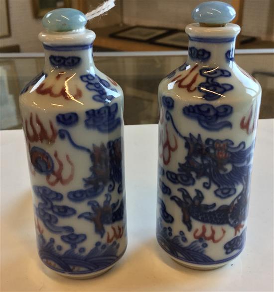 Pair 20th Century Chinese underglaze blue and copper red dragon snuff bottles